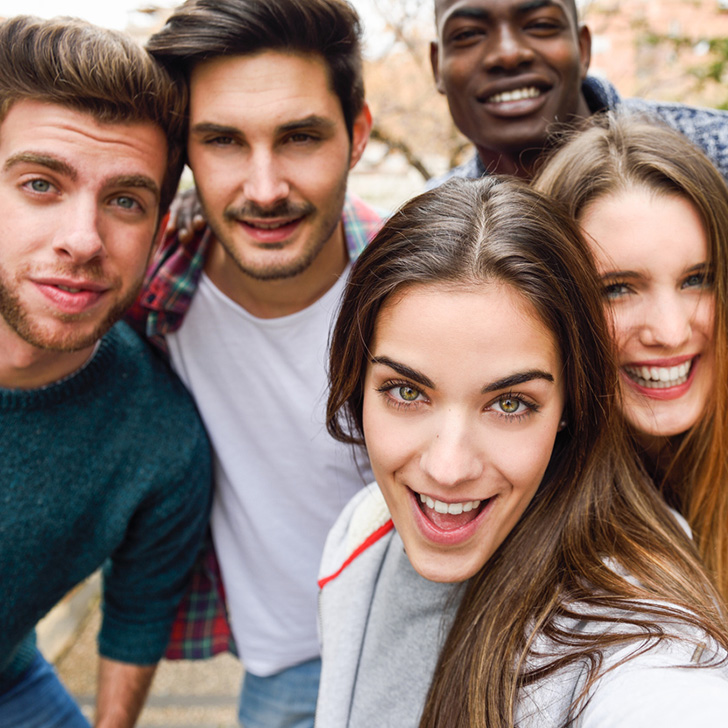group of 5 young people looking at camera